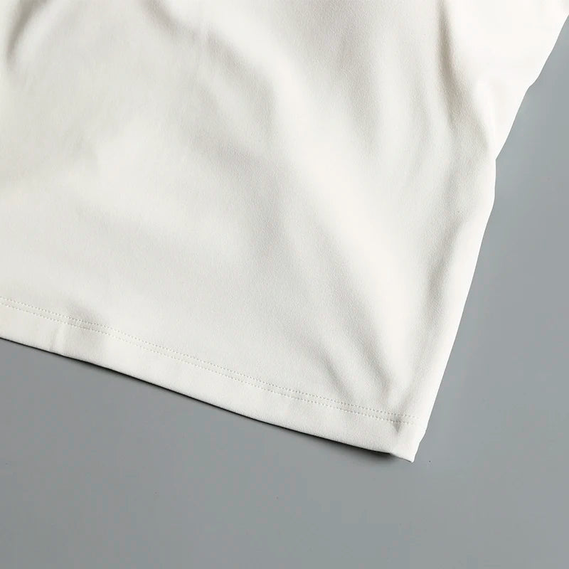 Camiseta deportiva corta sin espalda con almohadillas fijas en el pecho para mujer
